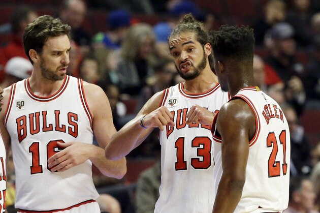 Chicago Bulls center/forward Joakim Noah (13) talks to guard E'Twaun Moore (55), forward/center Pau Gasol (16) and guard Jimmy Butler (21) during the first half of an NBA preseason basketball game against the Detroit Pistons on Wednesday, Oct. 14, 2015, in Chicago. (AP Photo/Nam Y. Huh)