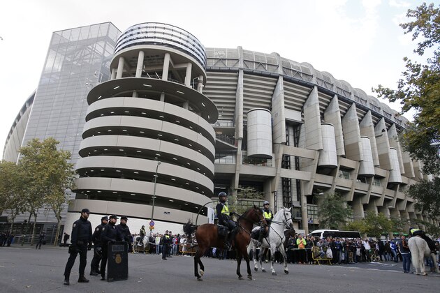 Police stand outside Real Madrid's Santiago Bernabeu stadium in Madrid, Spain, Saturday, Nov. 21, 2015.  Unprecedented security measures are in place for the first clasico of the season between Real Madrid and Barcelona, with nearly 3,000 policemen and private security officers dispatched to guarantee public safety at the Santiago Bernabeu stadium in Madrid. (AP Photo/Paul White)