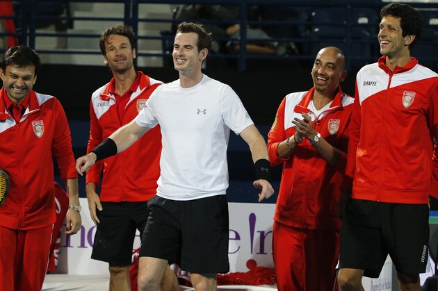 Britain's Andy Murray (C) of OUE Singapore Slammers celebrates after beating Australia's Bernard Tomic of Micromax Indian Aces during their tennis match in the men's singles of the International Premier Tennis League (IPTL) on December 16, 2015 in the United Emirate of Dubai. AFP PHOTO / KARIM SAHIB / AFP / KARIM SAHIB        (Photo credit should read KARIM SAHIB/AFP/Getty Images)