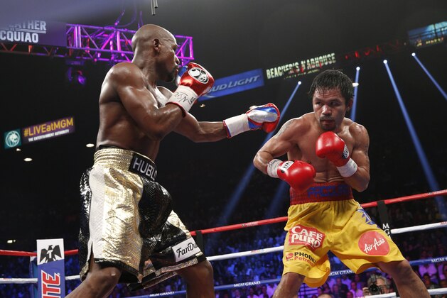 Floyd Mayweather Jr. exchange punches with Manny Pacquiao during their welterweight unification championship bout, May 2, 2015 at MGM Grand Garden Arena in Las Vegas, Nevada. Mayweather defeated Pacquiao by unanimous decision. AFP PHOTO / JOHN GURZINKSI (Photo credit should read JOHN GURZINSKI/AFP/Getty Images) Floyd Mayweather Jr. exchange punches with Manny Pacquiao during their welterweight unification championship bout, May 2, 2015 at MGM Grand Garden Arena in Las Vegas, Nevada. Mayweather defeated Pacquiao by unanimous decision. AFP PHOTO / JOHN GURZINKSI (Photo credit should read JOHN GURZINSKI/AFP/Getty Images)