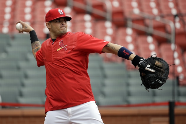 St. Louis Cardinals catcher Yadier Molina throws during baseball practice on Wednesday, Oct. 7, 2015, in St. Louis. Molina has been out since Sept. 20 with a partially torn ligament in his left thumb but expects to play while wearing a splint when the Cardinals faces either the Pittsburgh Pirates or the Chicago Cubs in Game 1 of the NLDS on Friday in St. Louis. (AP Photo/Jeff Roberson)