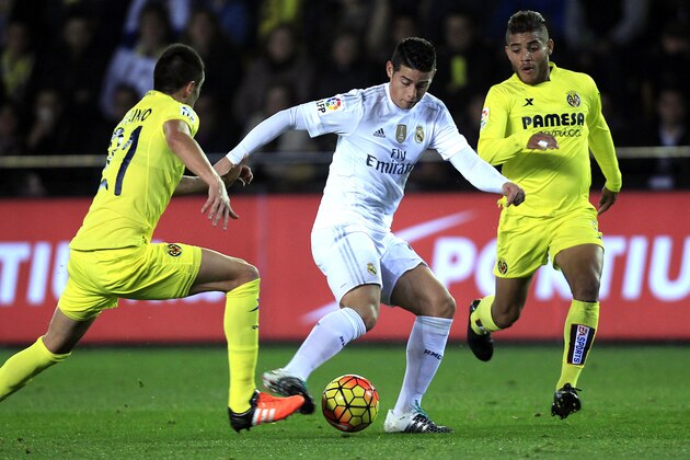 Real Madrid's James Rodriguez, center, duels for the ball with Villarreal's Bruno Soriano, left,  during a Spanish La Liga soccer match at the Madrigal stadium in Villarreal, Spain, Sunday, Dec. 13, 2015. (AP Photo/Alberto Saiz)