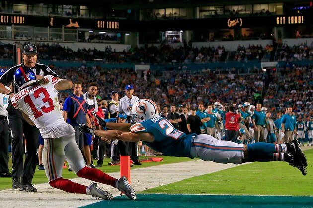 MIAMI GARDENS, FL - DECEMBER 14: Odell Beckham #13 of the New York Giants catches a touchdown pass as Brent Grimes #21 of the Miami Dolphins defends during the third quarter of the game at Sun Life Stadium on December 14, 2015 in Miami Gardens, Florida.  (Photo by Chris Trotman/Getty Images)