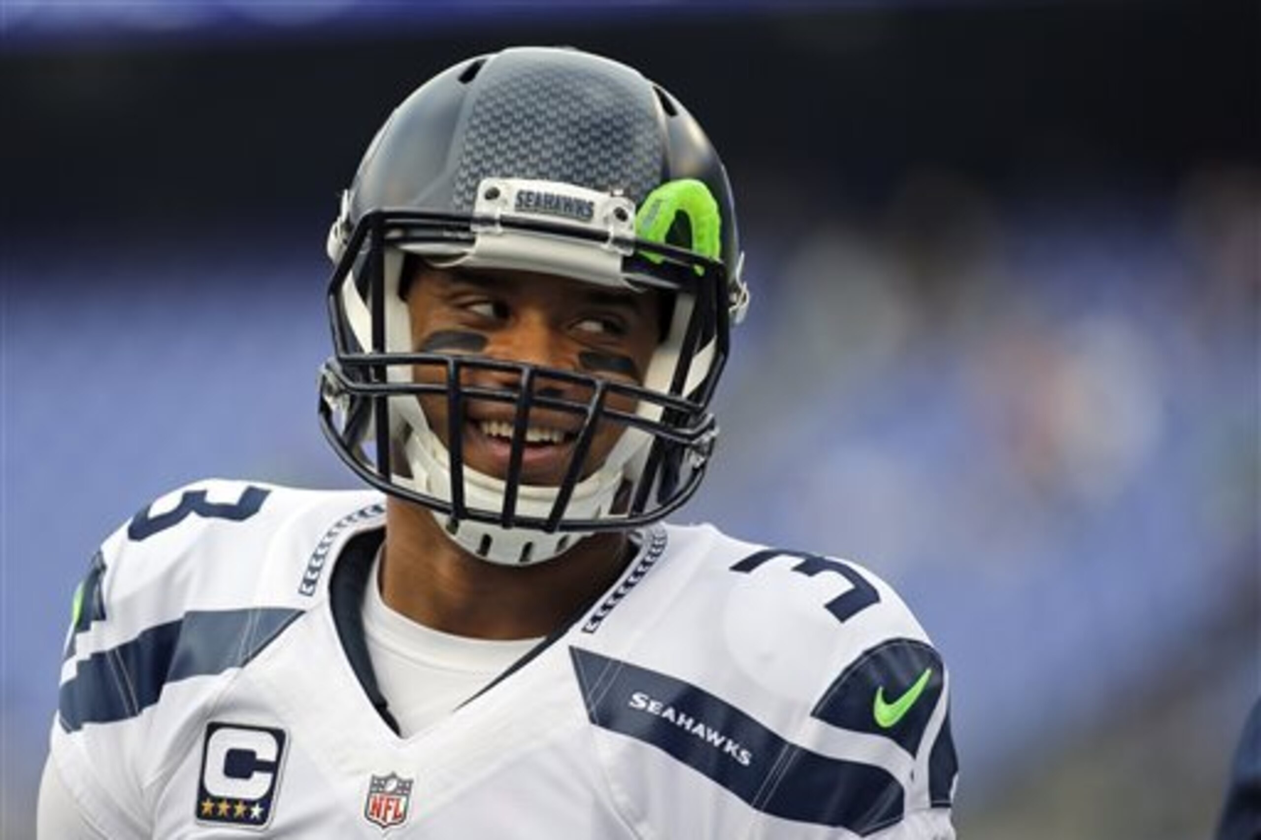 FILE - In this Dec. 13, 2015, file photo, Seattle Seahawks quarterback Russell Wilson (3) smiles during warms up before an NFL football game against the Baltimore Ravens, in Baltimore. Russell Wilson has it all put together. Johnny Manziel has been nothing but chaos since entering the NFL. The two players with similar football skills meet for the first time on Sunday.(AP Photo/Patrick Semansky, File)