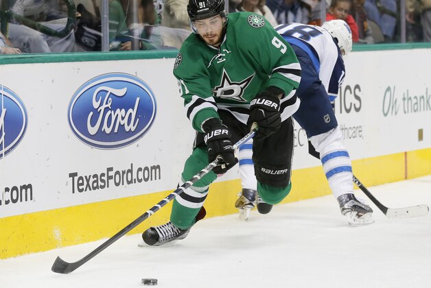 Dallas Stars' Tyler Seguin (91) wins control of the puck against Winnipeg Jets' Bryan Little (18) in the second period of an NHL hockey game Thursday, Nov. 12, 2015, in Dallas. (AP Photo/Tony Gutierrez)