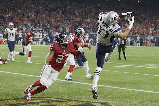 HOUSTON, TX - DECEMBER 13: Rob Gronkowski #87 of the New England Patriots catches a touchdown pass against Quintin Demps #27 of the Houston Texans in the second quarter on December 13, 2015 at NRG Stadium in Houston, Texas. (Photo by Bob Levey/Getty Images)