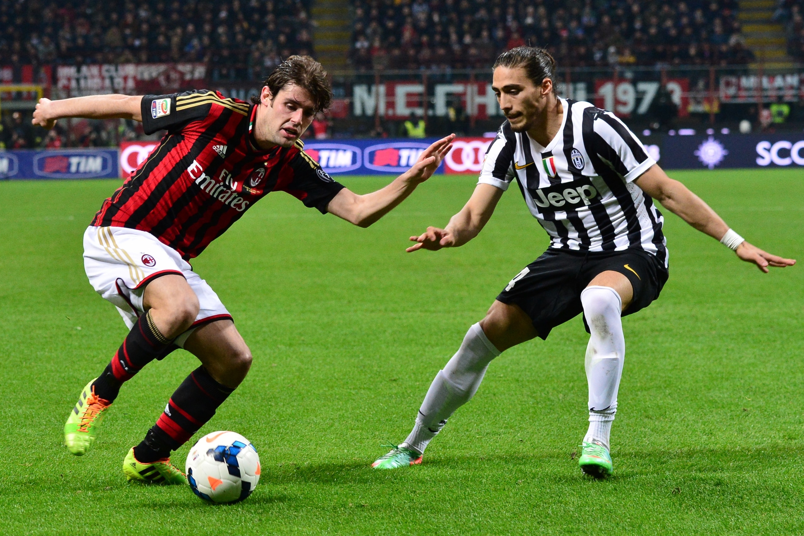 AC Milan's midfielder Andrea Poli (L) fights for the ball with Juventus' Uruguayan defender Jose Martin Caceres during the Serie A football match between AC Milan and Juventus at San Siro Stadium in Milan on March 2, 2014 . AFP PHOTO / GIUSEPPE CACACE        (Photo credit should read GIUSEPPE CACACE/AFP/Getty Images)
