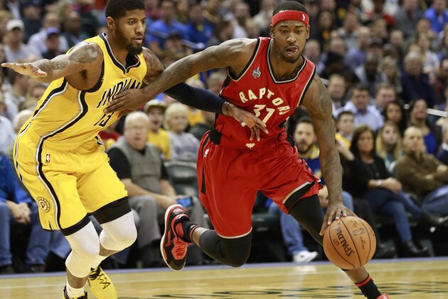 Toronto Raptors guard Terrence Ross, right,drives around Indiana Pacers forward Paul George, left, in the first half of an NBA basketball game, Monday, Dec. 14, 2015, in Indianapolis. (AP Photo/R Brent Smith)