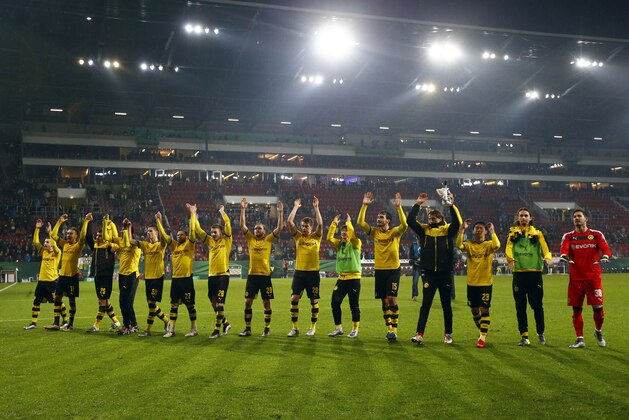 Dortmund's players celebrate to their supporters after the German soccer cup (DFB Pokal) match between FC Augsburg and Borussia Dortmund at the WWK Arena stadium in Augsburg, Germany, Wednesday, Dec. 16, 2015. Dortmund won 2-0. (AP Photo/Matthias Schrader)