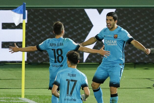 FC Barcelona's Luis Suarez, right, is congratulated by teammates Jordi Alba, left, and Sergi Roberto after scoring a goal against Guangzhou Evergrande FC during their semifinal match at the FIFA Club World Cup soccer tournament in Yokohama, near Tokyo, Thursday, Dec. 17, 2015. (AP Photo/Shuji Kajiyama)