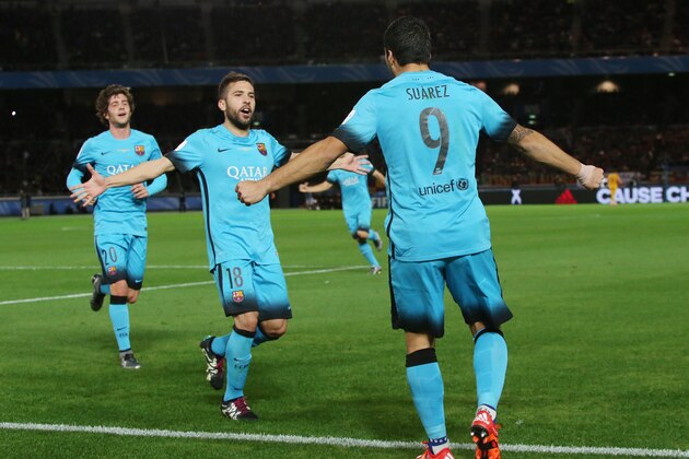FC Barcelona's Luis Suarez, right, is congratulated by teammates Jordi Alba and Sergi Roberto, left, after scoring a goal against Guangzhou Evergrande FC during their semifinal match at the FIFA Club World Cup soccer tournament in Yokohama, near Tokyo, Thursday, Dec. 17, 2015. (AP Photo/Eugene Hoshiko)