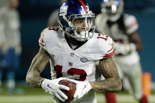 New York Giants wide receiver Odell Beckham (13) runs for a touchdown during the second half of an NFL football gam against the Miami Dolphins, Monday, Dec. 14, 2015, in Miami Gardens, Fla.  (AP Photo/Wilfredo Lee)