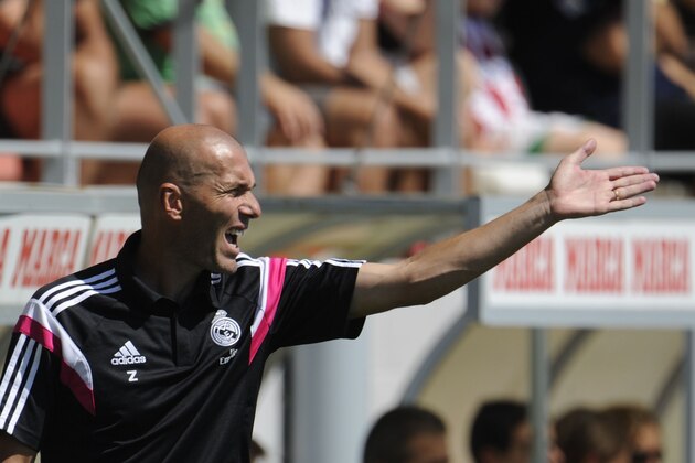 Former French football star and new coach of Real Madrid Castilla Zinedine Zidane gestures during the Spanish League B football match Real Madrid Castilla vs Atletico de Madrid at the Cerro del Espino stadium in Majadahonda, near Madrid on august 24, 2014.   AFP PHOTO/ PEDRO ARMESTRE        (Photo credit should read PEDRO ARMESTRE/AFP/Getty Images)