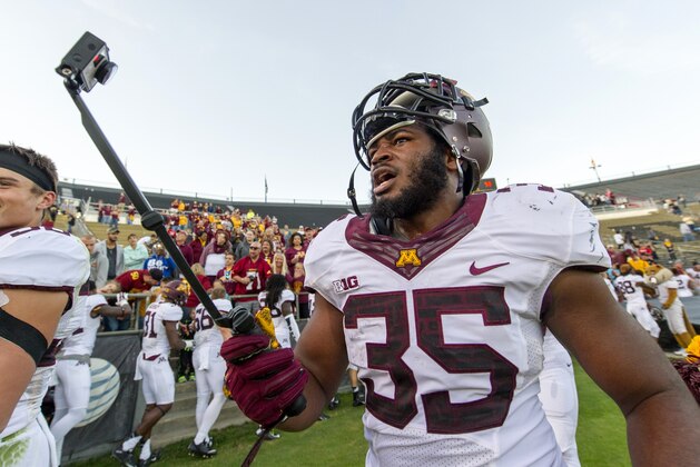 Minnesota Golden Gophers running back Rodrick Williams Jr (35) records his post-game celebration with his teammates using a GoPro camera after defeating Purdue in an NCAA college football game, Saturday, Oct. 10, 2015, in West Lafayette, Ind. Minnesota won 41-13. (AP Photo/Doug McSchooler)