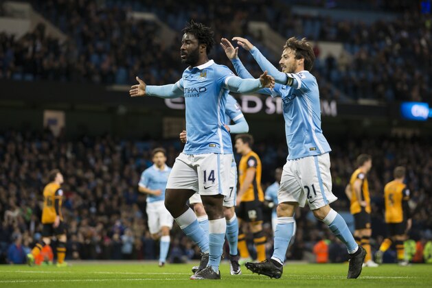 Manchester City's Wilfried Bony, centre, is congratulated by teammate David Silva after scoring during the English League Cup soccer match between Manchester City and Hull City at the Etihad Stadium, Manchester, England, Tuesday, Dec. 1, 2015. (AP Photo/Jon Super)