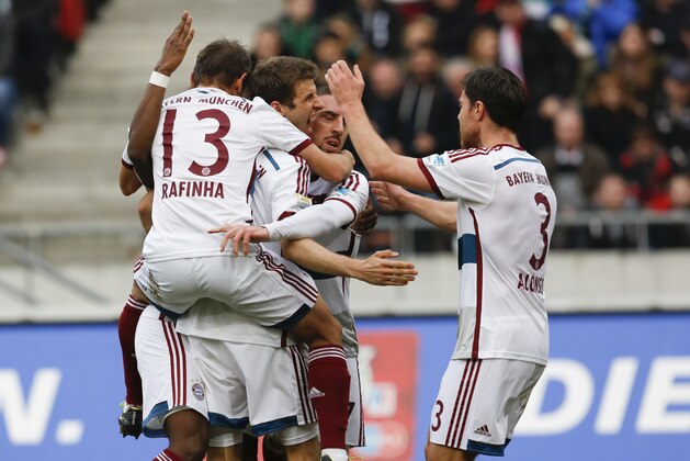 Bayern's Thomas Mueller, center, celebrates with teammates after his side's  second goal during the German first division Bundesliga soccer match between Hannover 96 and Bayern Munich in Hannover, Germany, Saturday, March 7, 2015. (AP Photo/Markus Schreiber)
