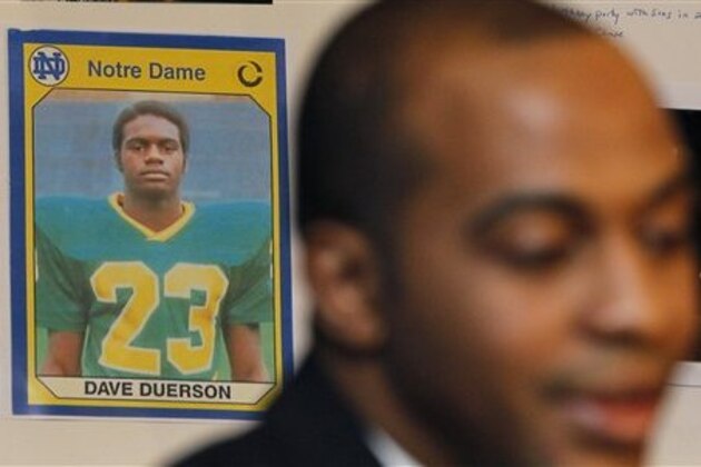 An undated photograph of former Chicago Bears Dave Duerson, while he was playing at Notre Dame, hangs behind his son Tregg, as Tregg announces the filing of a wrongful death lawsuit against the NFL, during a news conference Thursday, Feb. 23, 2012, in Chicago. The lawsuit accuses the NFL of negligently causing the brain damage that led Duerson to take his own life at the age of 50 by not warning him of the negative effects of concussions. (AP Photo/Charles Rex Arbogast)