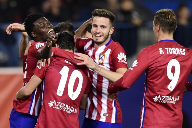 Atletico Madrid's Ghanaian midfielder Thomas Partey (L) celebrates a goal with teammates during the Spanish Copa del Rey (King's Cup) football match Club Atletico de Madrid VS CF Reus Deportivo at the Vicente Calderon stadium in Madrid on December 17, 2015.   AFP PHOTO / JAVIER SORIANO / AFP / JAVIER SORIANO        (Photo credit should read JAVIER SORIANO/AFP/Getty Images)
