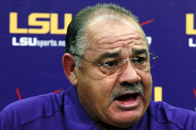 FILE - In this Aug. 7, 2012, file photo, then-LSU defensive coordinator John Chavis talks to reporters during their NCAA college football media day in Baton Rouge, La. The SEC will have 14 new coordinators this season. In typical SEC style, some have been spare-no-expense hires. Defensive coordinators Will Muschamp of Auburn and John Chavis of Texas A&M are each making at least $5 million over the next three years at their new jobs.(AP Photo/Gerald Herbert, File)