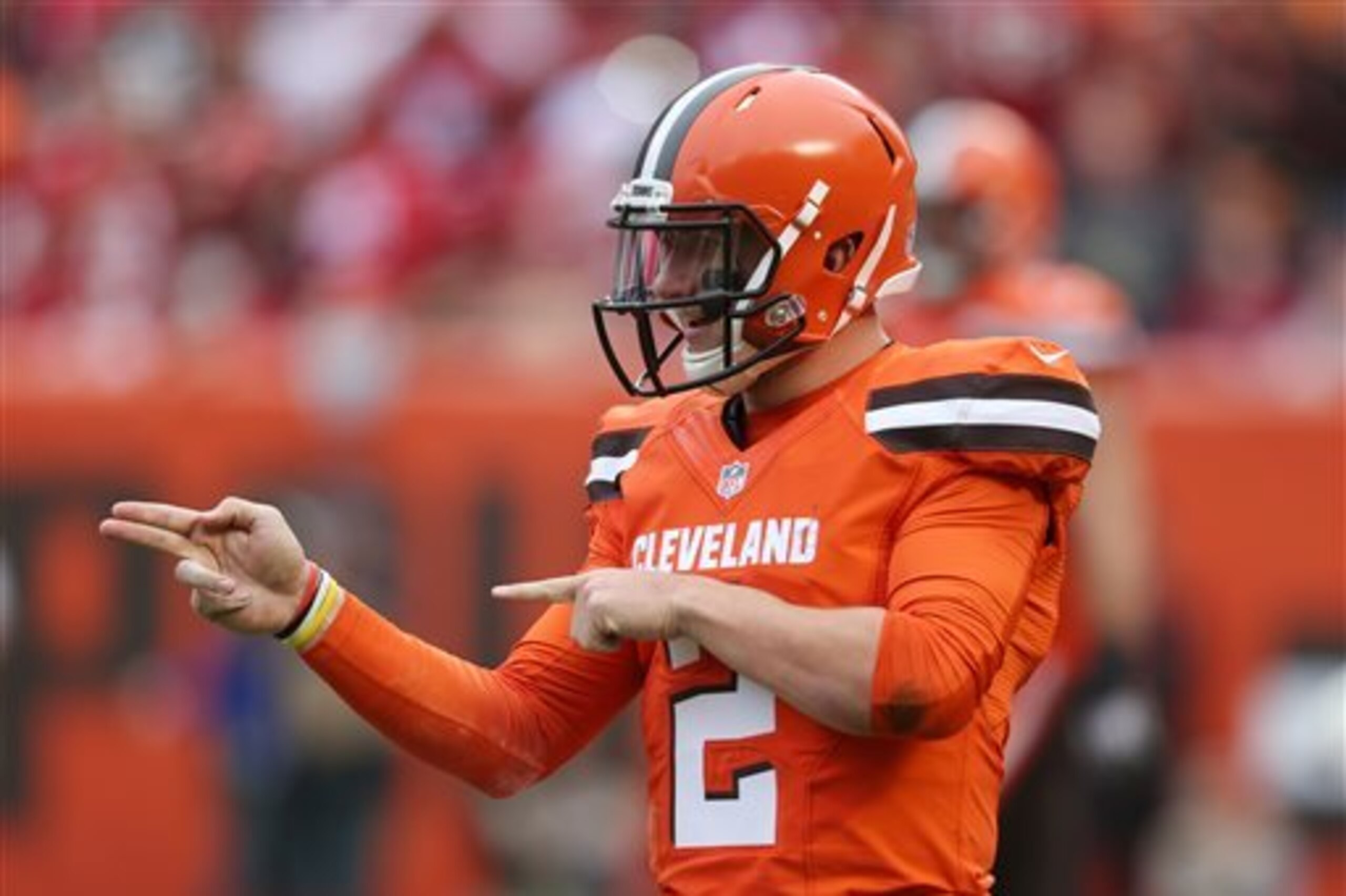 FILE - In this Dec. 13, 2015, file photo, Cleveland Browns quarterback Johnny Manziel (2) gestures during the first half of an NFL game against the San Francisco 49ers, in Cleveland. Russell Wilson has it all put together. Johnny Manziel has been nothing but chaos since entering the NFL. The two players with similar football skills meet for the first time on Sunday.(AP Photo/Ron Schwane, File)