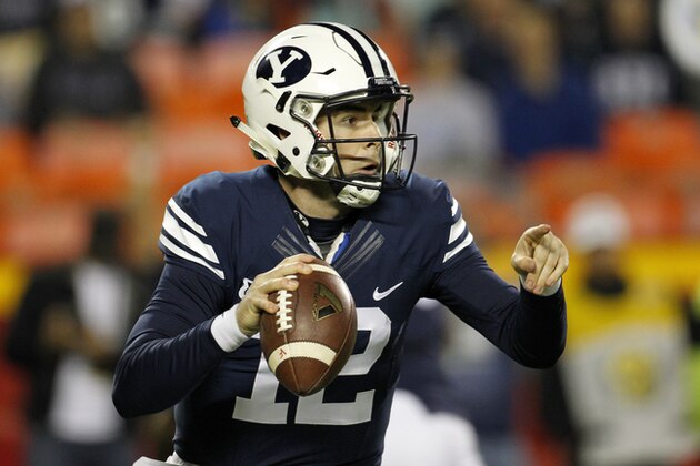 BYU quarterback Tanner Mangum (12) looks downfield in the first half of a college football game against Missouri at Arrowhead Stadium, Saturday, Nov. 14, 2015, in Kansas City, Mo. (AP Photo/Colin E. Braley)
