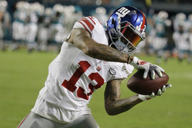 New York Giants wide receiver Odell Beckham (13) makes a catch before an NFL football game against the Miami Dolphins, Monday, Dec. 14, 2015, in Miami Gardens, Fla.  (AP Photo/Lynne Sladky)