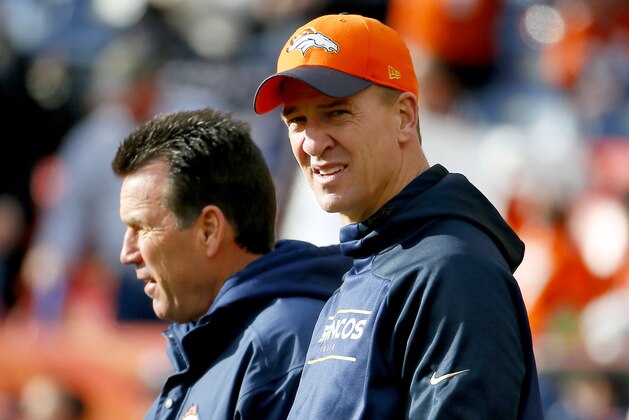 Denver Broncos quarterback Peyton Manning, right, watches warm ups with Denver Broncos head coach Gary Kubiak prior to an NFL football game against the Oakland Raiders, Sunday, Dec. 13, 2015, in Denver. (AP Photo/Jack Dempsey)