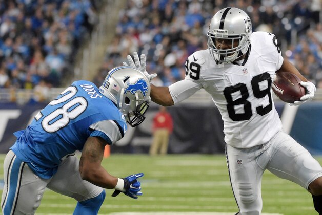 Nov 22, 2015; Detroit, MI, USA; Oakland Raiders wide receiver Amari Cooper (89) carries the ball as Detroit Lions cornerback Quandre Diggs (28) defends at Ford Field. The Lions won 18-13. Mandatory Credit: Kirby Lee-USA TODAY Sports