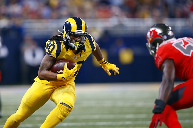 St. Louis Rams running back Todd Gurley, left, runs with the ball as Tampa Bay Buccaneers outside linebacker Lavonte David defends during the second quarter of an NFL football game on Thursday, Dec. 17, 2015, in St. Louis. (AP Photo/Billy Hurst)