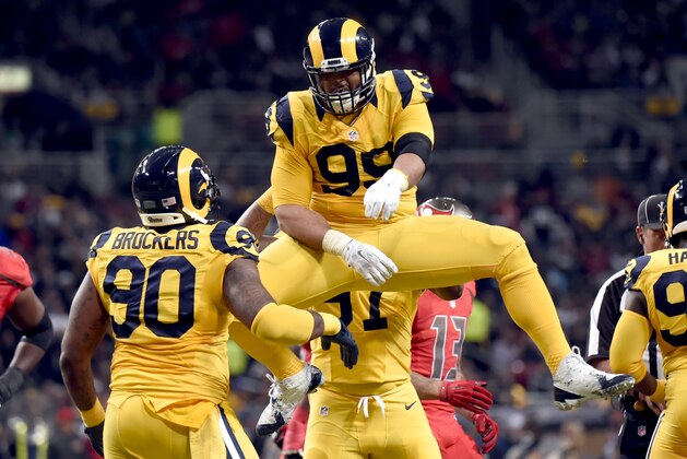 St. Louis Rams defensive tackle Aaron Donald, top celebrates with teammate Michael Brockers (90) after stopping Tampa Bay Buccaneers running back Charles Sims for a 2-yard loss during the second quarter of an NFL football game Thursday, Dec. 17, 2015, in St. Louis. (AP Photo/L.G. Patterson)