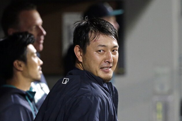 Seattle Mariners starting pitcher Hisashi Iwakuma smiles after leaving the baseball game Friday, Oct. 2, 2015, in Seattle. (AP Photo/Elaine Thompson)