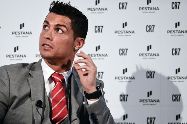 Real Madrid's player Cristiano Ronaldo looks on during a press conference at Pestana Hotel Palace in Lisbon on December 17, 2015. Cristiano Ronaldo will invest over 37 million euros in the Pestana hotel group to create four new hotels with the 'CR7' logo in Portugal, Madrid and New York.   AFP PHOTO / PATRICIA DE MELO MOREIRA / AFP / PATRICIA DE MELO MOREIRA        (Photo credit should read PATRICIA DE MELO MOREIRA/AFP/Getty Images)