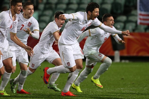 Marko Grujic of Serbia (2nd R) leads teammates as they celebrate their victory during a penalty shootout during the FIFA U20 World Cup quarter-final match between the USA and Serbia in Auckland on June 14, 2015.     AFP PHOTO / Fiona GOODALL        (Photo credit should read Fiona GOODALL/AFP/Getty Images)
