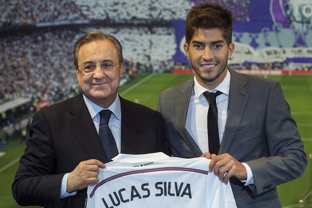 Brazil international soccer player Lucas Silva, right, and Real Madrid President Florentino Perez pose during Silva's official presentation at the Santiago Bernabeu stadium in Madrid, Spain, Monday, Jan. 26, 2015, after signing for Real Madrid. (AP Photo/Andres Kudacki)