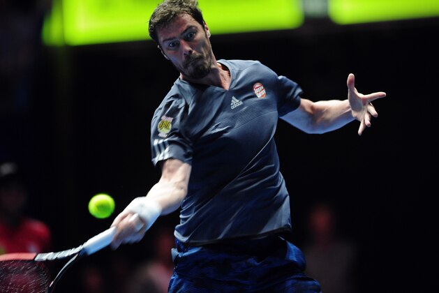 Russia's Marat Safin of Japan Warriors hits a return against US player James Blake of Philippine Mavericks during their men's singles match at the International Premier Tennis League (IPTL) tournament in Singapore on December 18, 2015. AFP PHOTO / MOHD FYROL / AFP / MOHD FYROL        (Photo credit should read MOHD FYROL/AFP/Getty Images)