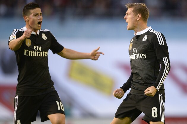 Real Madrid's German midfielder Toni Kroos (R) celebrates with teammate Colombian midfielder James Rodriguez after scoring a goal during the Spanish league football match Celta Vigo vs  Real Madrid CF at the Balaidos stadium in Vigo on April 26, 2015.  AFP PHOTO/ MIGUEL RIOPA        (Photo credit should read MIGUEL RIOPA/AFP/Getty Images)