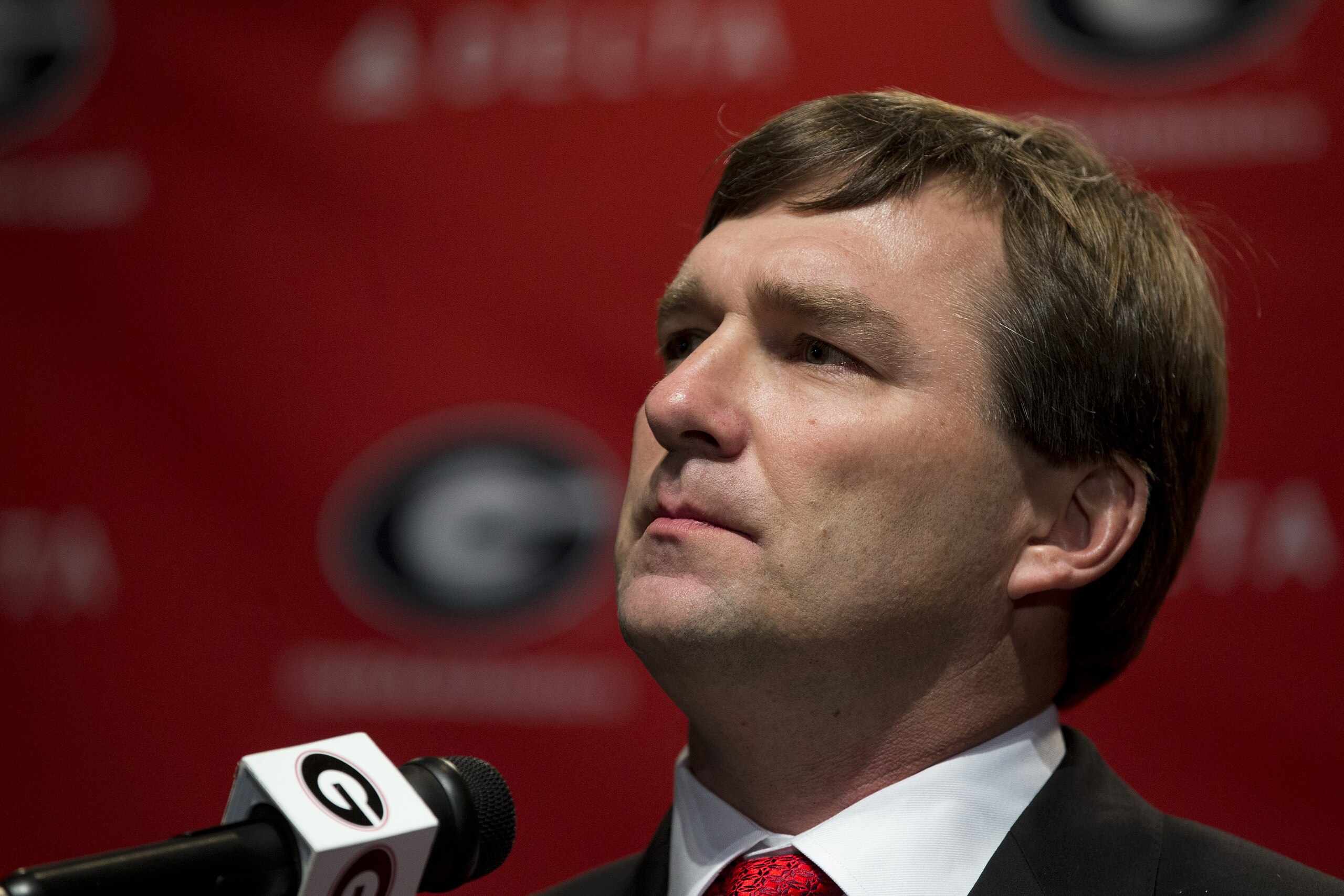 Alabama defensive coordinator Kirby Smart listens to a question from a reporter during a press conference where he was introduced as Georgia's new head football coach  Monday, Dec. 7, 2015, in Athens, Ga. Smart will stay with the Crimson Tide through the NCAA college playoffs. (AP Photo/John Bazemore)