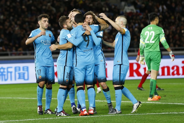 FC Barcelona’s Luis Suarez (9) is celebrated by teammates after scoring his second goal against Guangzhou Evergrande FC during their semifinal match at the FIFA Club World Cup soccer tournament in Yokohama, near Tokyo, Thursday, Dec. 17, 2015. At right is Guangzhou Evergrande FC goalkeeper Li Shuai. (AP Photo/Shizuo Kambayashi)