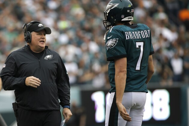 Philadelphia Eagles’ Chip Kelly, left, and Sam Bradford talk during the first half of an NFL football game against the Buffalo Bills, Sunday, Dec. 13, 2015, in Philadelphia. (AP Photo/Michael Perez)