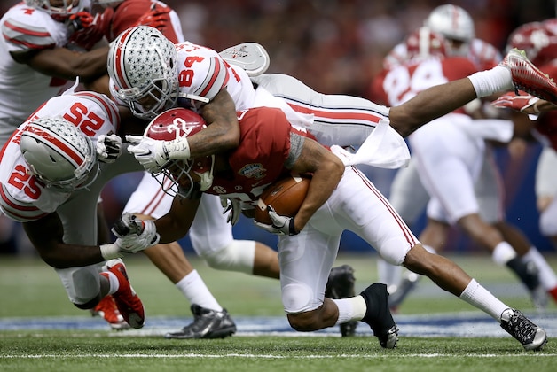 NEW ORLEANS, LA - JANUARY 01:  Corey Smith #84 of the Ohio State Buckeyes tackeles Christion Jones #22 of the Alabama Crimson Tide during the All State Sugar Bowl at the Mercedes-Benz Superdome on January 1, 2015 in New Orleans, Louisiana.  (Photo by Chris Graythen/Getty Images)