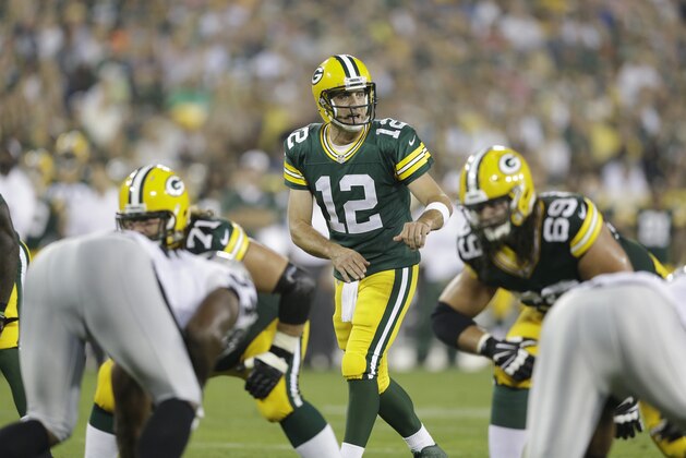 Green Bay Packers' Aaron Rodgers during the first half of an NFL preseason football game against the Oakland Raiders Friday, Aug. 22, 2014, in Green Bay, Wis. (AP Photo/Morry Gash)