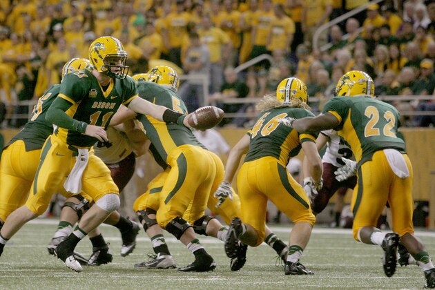 North Dakota State quarterback Carson Wentz  (11) hands off to running back King Frazier (22) against Montana during the second half of an NCAA college football game Saturday, Sept. 20, 2014, in Fargo, N.D. (AP Photo/Bruce Crummy)