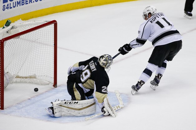 Los Angeles Kings' Anze Kopitar (11) scores on Pittsburgh Penguins goalie Marc-Andre Fleury (29) during a shootout of an NHL hockey game in Pittsburgh Friday, Dec. 11, 2015.(AP Photo/Gene J. Puskar)