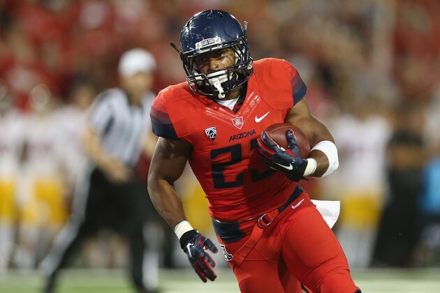 TUCSON, AZ - OCTOBER 11:  Running back Jared Baker #23 of the Arizona Wildcats rushes the football against the USC Trojans during the college football game at Arizona Stadium on October 11, 2014 in Tucson, Arizona. The Trojans defeatred the Wildcats 28-26.  (Photo by Christian Petersen/Getty Images)
