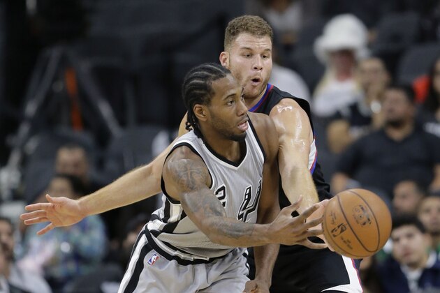 San Antonio Spurs forward Kawhi Leonard (2) is pressured by Los Angeles Clippers forward Blake Griffin during the first half of an NBA basketball game, Friday, Dec. 18, 2015, in San Antonio. (AP Photo/Eric Gay)