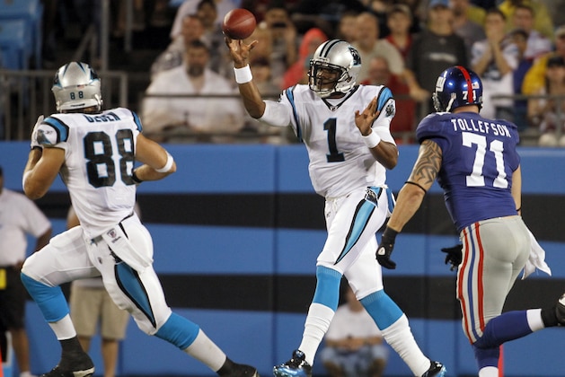Carolina Panthers' Cam Newton (1) throws a pass to Greg Olsen (88) as New York Giants' Dave Tollefson (71) defends in the second quarter of a preseason NFL football game in Charlotte, N.C., Saturday, Aug. 13, 2011. (AP Photo/Bob Leverone)