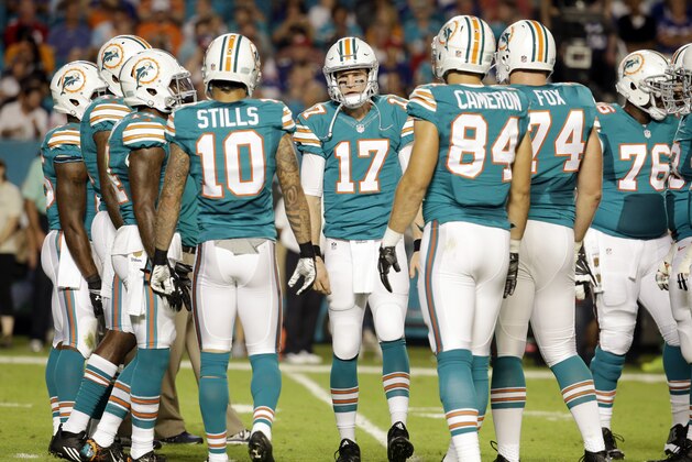 Miami Dolphins quarterback Ryan Tannehill (17) talks to the offensive line during the first half of an NFL football game against the New York Giants, Monday, Dec. 14, 2015, in Miami Gardens, Fla.  (AP Photo/Lynne Sladky)