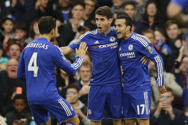 Chelsea's Pedro, right, celebrates scoring his side's second goal with Cesc Fabregas, left, and Oscar, during the English Premier League soccer match between Chelsea and Sunderland at Stamford Bridge stadium in London, Saturday, Dec. 19, 2015.  (AP Photo/Matt Dunham)