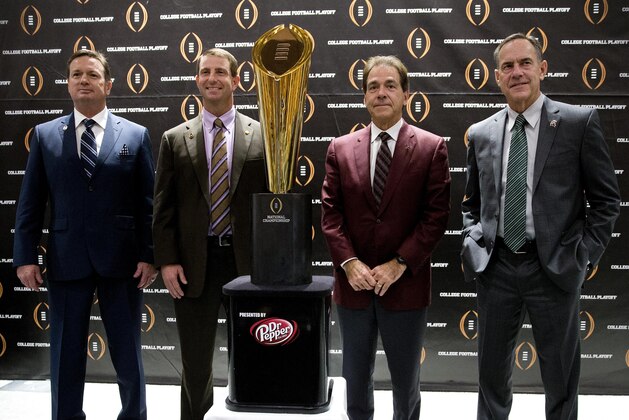 College football playoff coaches from left; Bob Stoops, of Oklahoma, Dabo Swenney, of Clemson, Nick Saban, of Alabama and Mark  Dontonio, of Michigan St., pose with the championship trophy after a news conference the college football awards at the College Football Hall of Fame  Thursday, Dec. 10, 2015, in Atlanta. Oklahoma and Clemson will meet in the Orange Bowl and Alabama and Michigan St. will play in the Cotton Bowl. (AP Photo/John Bazemore)