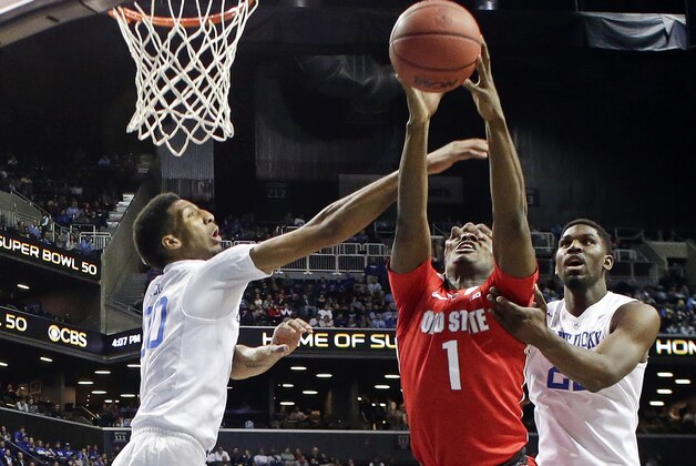 Kentucky's Marcus Lee (00) and Alex Poythress (22) defends Ohio State's Jae'Sean Tate (1)  during the first half of an NCAA college basketball game Saturday, Dec. 19, 2015, in New York. (AP Photo/Frank Franklin II)